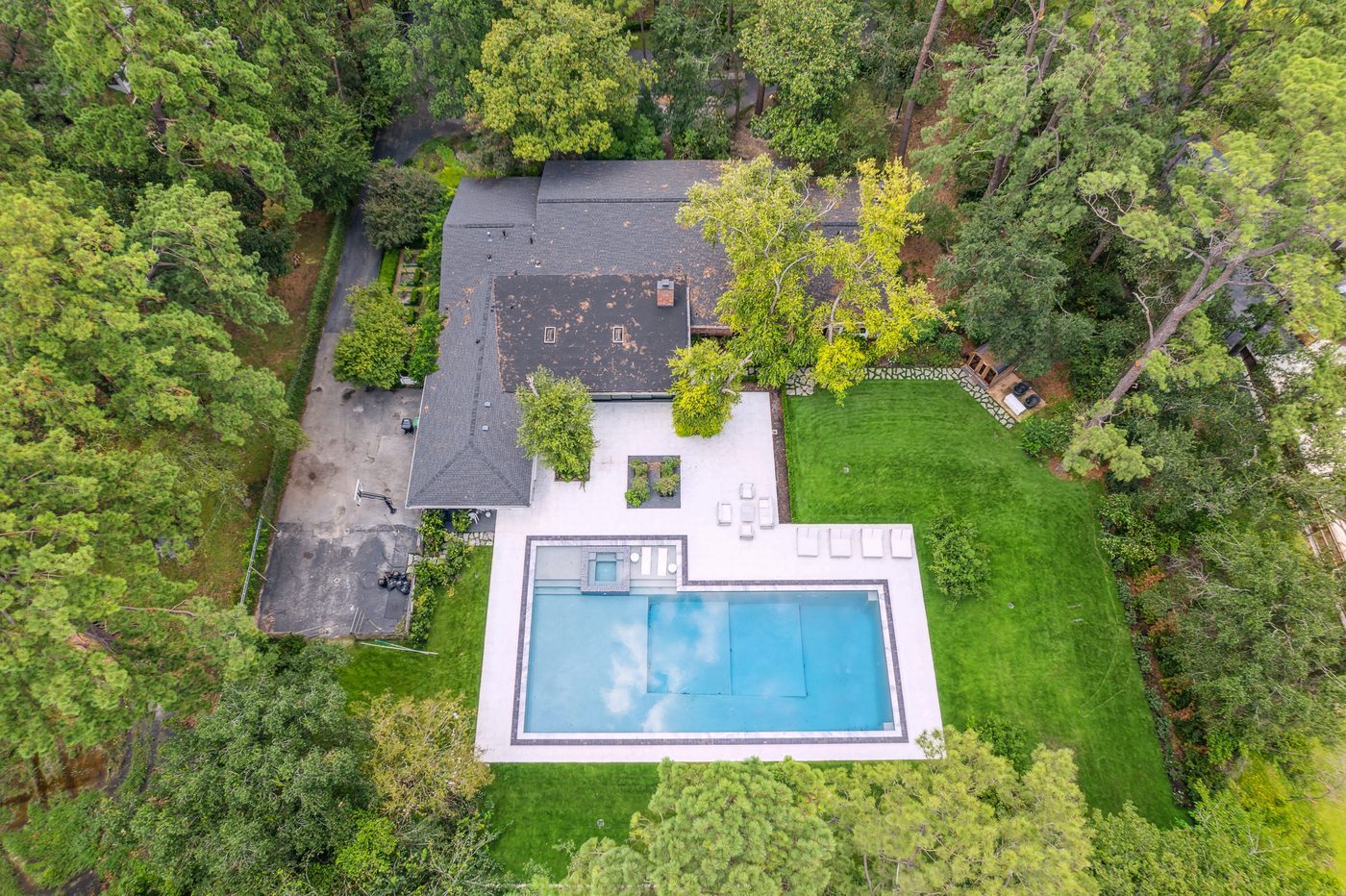 Aerial view of the Shadow Sanctuary property showing the two-acre wooded lot and pool deck.